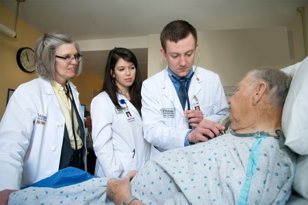 Dr. Fraser and students examine patient